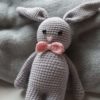 Amigurumi lapin de couleur grise avec un noeud de paillon