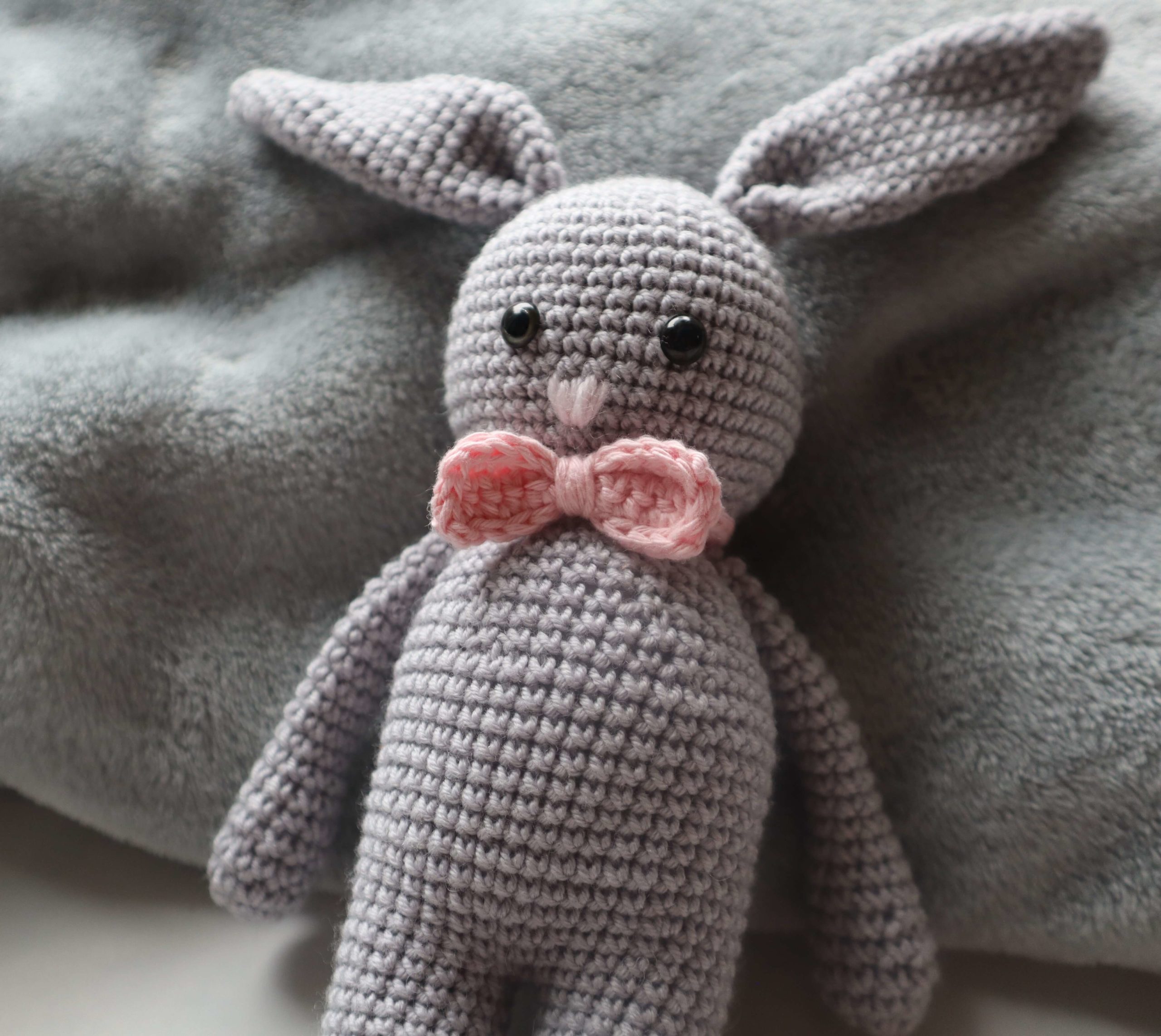 Amigurumi lapin de couleur grise avec un noeud de paillon